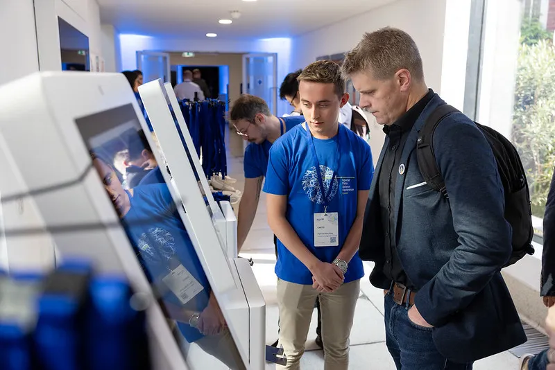 Gentleman getting his conference pass on the door of The Royal Geographical Society,