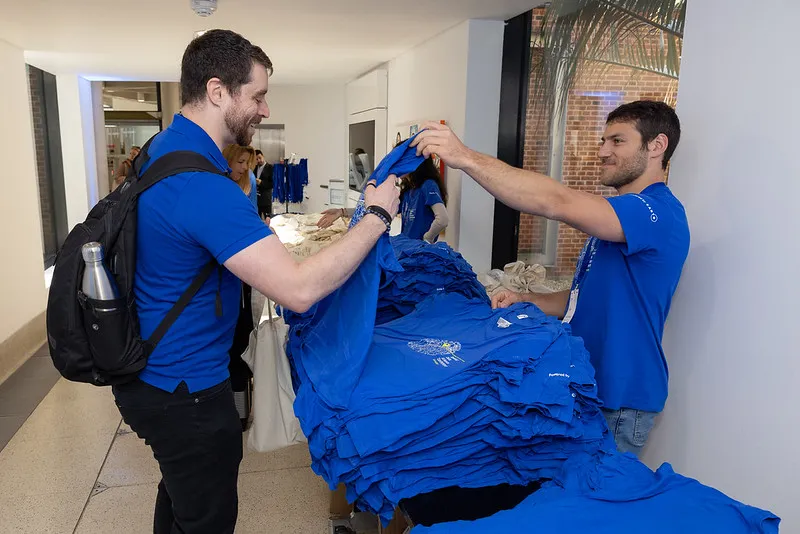 A guy very excited as he receives his SDSC t shirt.